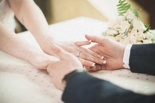 engaged couple holding hands