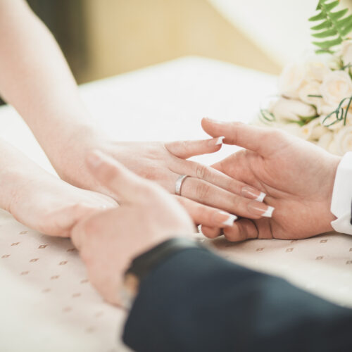 engaged couple holding hands